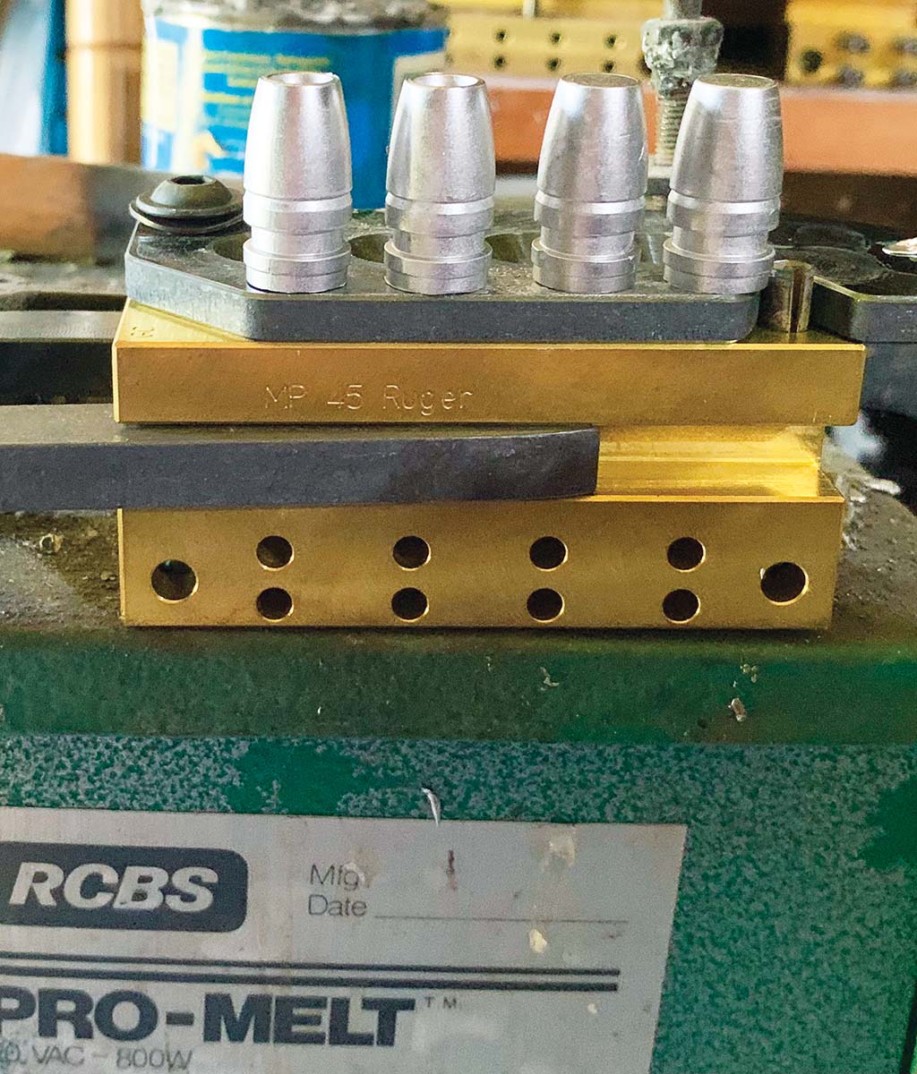 A close-up of an MP Molds 45 Ruger Only mold and fresh cast bullets.